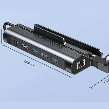A black multi-port USB hub with an integrated cable adapter and clip, shown with dimension labels (158mm length, 67mm adapter, 25mm cable) on a light blue background.