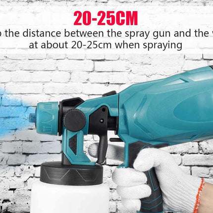 A teal and black electric paint spray gun held by a gloved hand, with a white wall background and blue spray mist visible. Text at the top reads '20-25CM Keep the distance between the spray gun and the wall at about 20-25cm when spraying'.