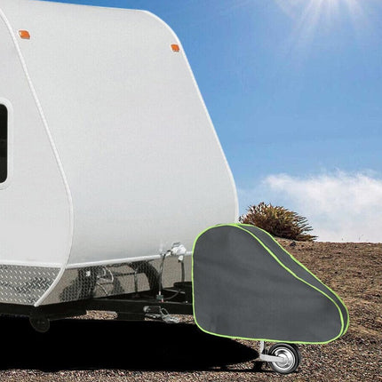 Black and green RV bumper cover on a trailer with a clear sky background