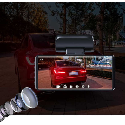 Car monitor with a view of a red car on a screen, placed on a car's roof.