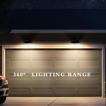 A garage door at night with two overhead lights illuminating the front, plus the text '360° LIGHTING RANGE' overlaid across the door. Part of a vehicle is visible on the left and plants sit on the right.