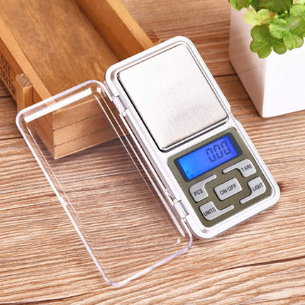 Digital pocket scale on a wooden surface with a clear plastic cover