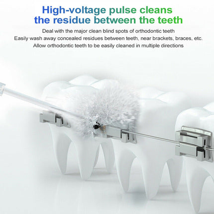 Teeth with orthodontic hardware and cleaning tool on a white background