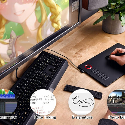 Workstation setup with computer monitor, keyboard, and drawing tablet on a desk.