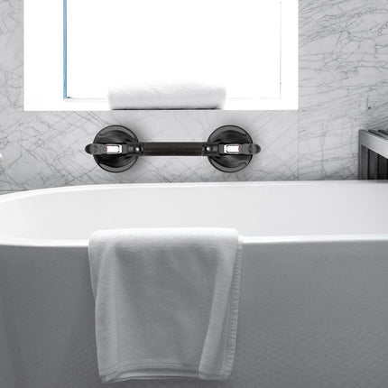 Modern bathroom with a freestanding bathtub, towel rack, and shower head.