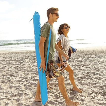 Two people walking on a beach with a blue surfboard