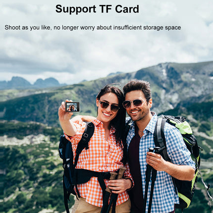 Couple hiking with backpacks, taking a selfie in a scenic mountain landscape.