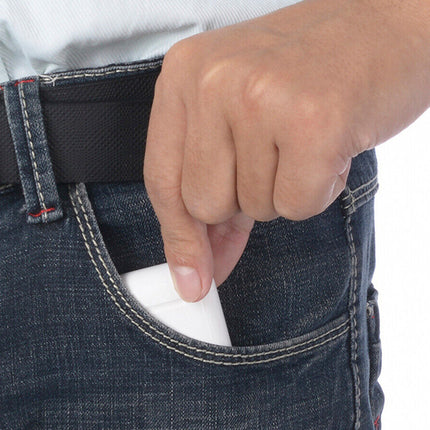 Person wearing jeans with a white object in the pocket against a white background