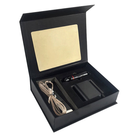 Black open box containing a pen, cable, and other items on a white background