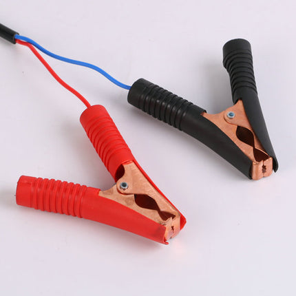 Red and black alligator clips with wires on a white background