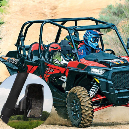 Four-wheeler with two people wearing helmets on a dirt path