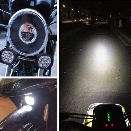 Motorcycle lights with close-up details and road illumination at night.