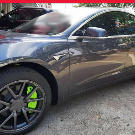 Car with a green rim on a street