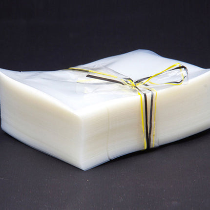 White rectangular package tied with a yellow ribbon on a black background