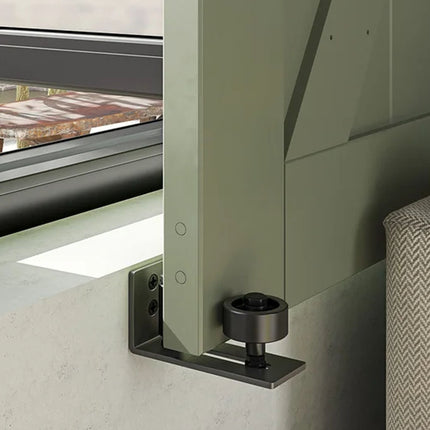 Close-up of a window bracket attached to a wall with a view of a patio outside.