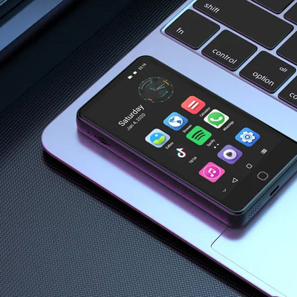 Smartphone with app icons on a laptop keyboard