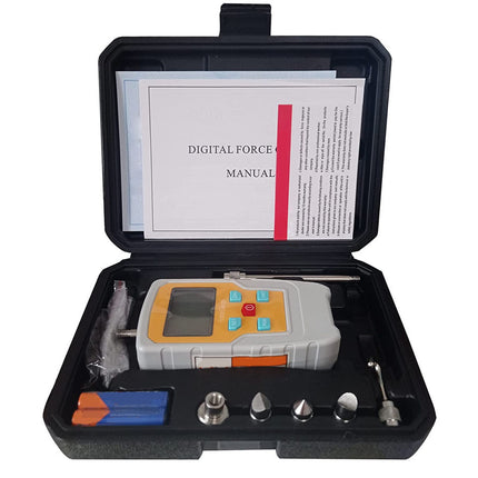 Digital force gauge in a black case with a manual on a white background
