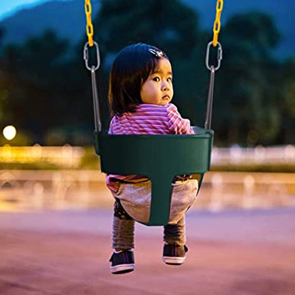 Child in a green swing at a playground with a blurred background