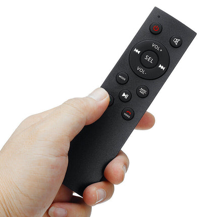 A hand holding a black remote control with volume and selection buttons, isolated on a white background.