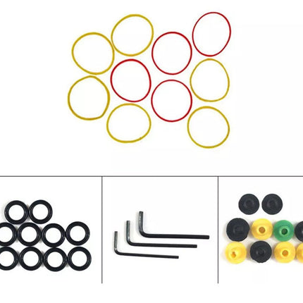 Set of colorful rubber bands and small metal tools on a white background