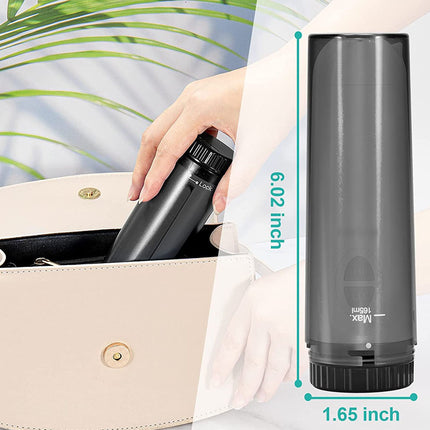 Hand holding a black water bottle with measurements displayed, against a blurred background.