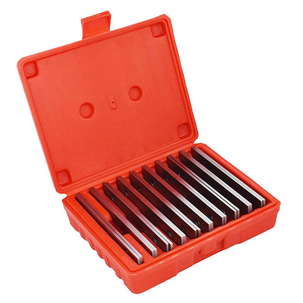 Set of metal tools in an open red case on a white background
