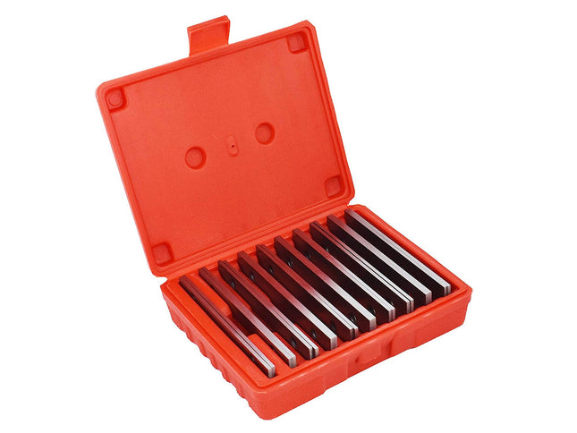 Set of metal tools in an open red case on a white background