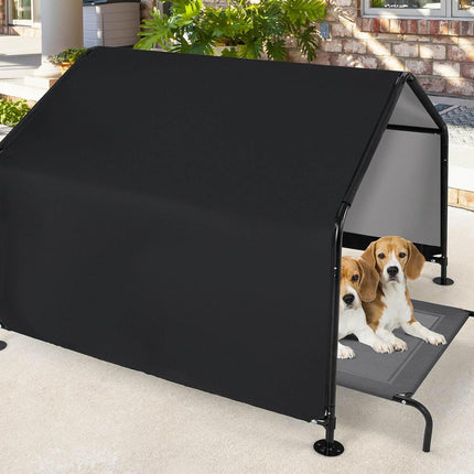 Two dogs on a black pet bed with a canopy in an outdoor setting.