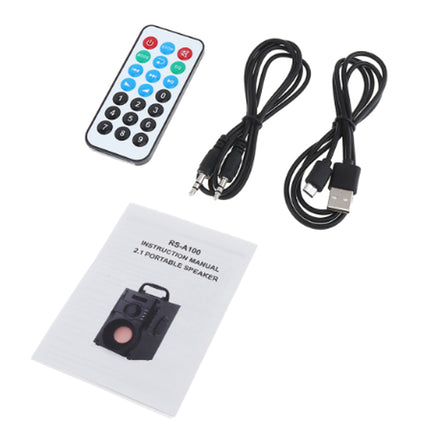 Portable speaker kit with remote control, cables, and manual on a white background