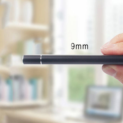 Hand holding a cylindrical object with '9mm' text against a blurred indoor background