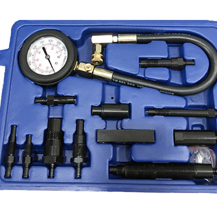 Mechanical pressure testing kit with gauge and various nozzles in a blue case.