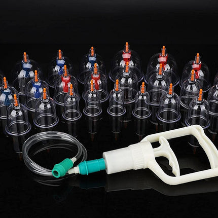 Set of cupping therapy cups with a pump on a black background