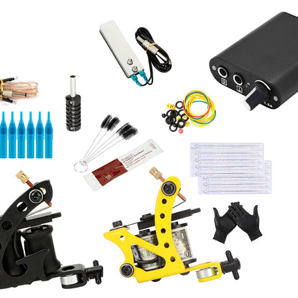 A tattoo kit laid out on a white background, including a black power bank, two tattoo machines (one black and one yellow), blue cartridge tips, ink cups, needles, grips, cleaning brushes, and other accessories.
