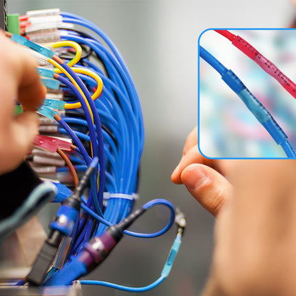 A close-up of hands working with bundled blue, yellow, red, and other colored cables connected to a device, with an inset detail showing a blue cable sleeve on a red cable.