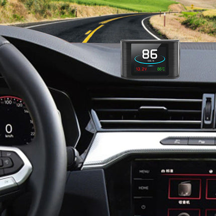 A car dashboard display mounted on the windshield showing speed and temperature, installed in a vehicle interior with a steering wheel and road visible.