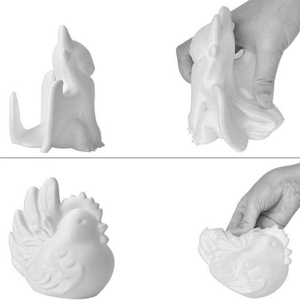 White ceramic rooster-shaped object being held and displayed on a white background