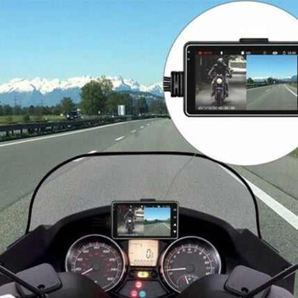 Motorcycle dashboard with a mounted camera showing a rider on a road with mountains in the background.