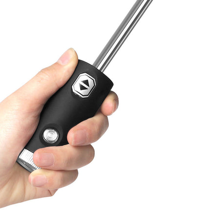 Hand holding a black screwdriver with a white background