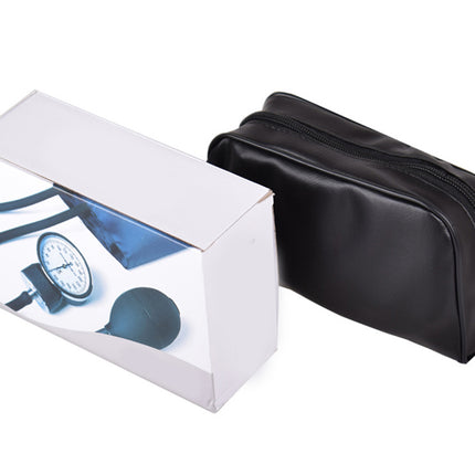 Black toiletry bag next to a white box with blue design on a white background