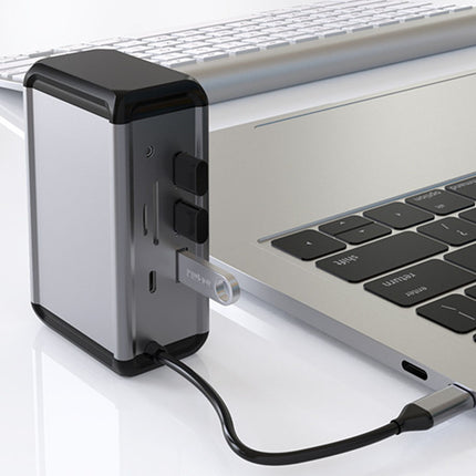 Laptop with a power adapter plugged into it on a white surface