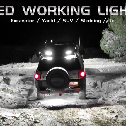 Off-road vehicle with LED working lights on a rocky terrain at night.