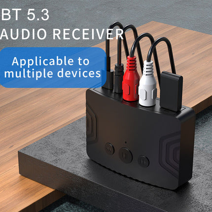 Black audio receiver with multiple device charging ports on a wooden surface