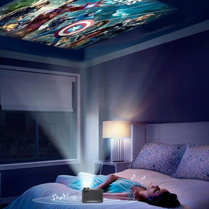 Woman lying on a bed watching superhero movie on a projector screen in a dark room