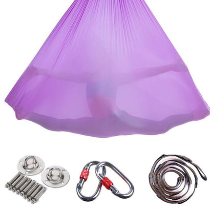 Purple aerial yoga hammock with accessories on a white background