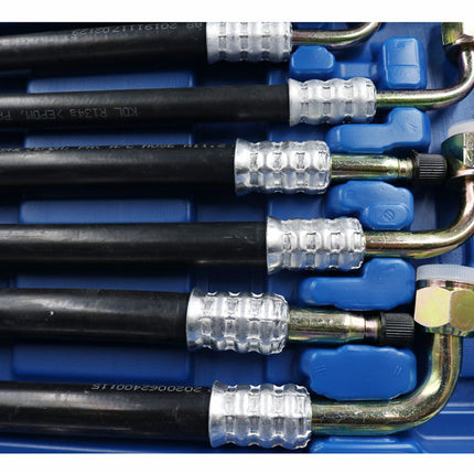 Set of automotive tools including pressure testing kits on a blue background