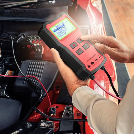 Person using a diagnostic tool on a car battery
