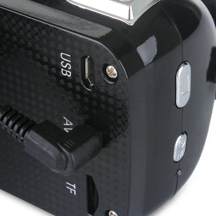 Close-up of a black electronic device with USB, AV, and TF ports on a white background