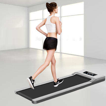 Woman exercising on a treadmill in a bright room