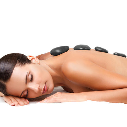 Woman receiving a hot stone massage on a white background
