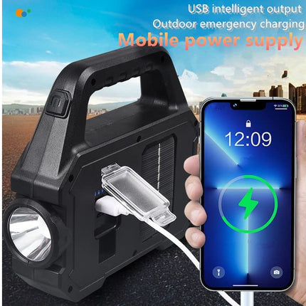 Black portable power station with flashlight and phone charging, outdoor emergency use.